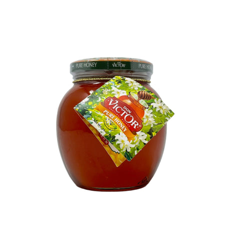 Jar of Don Victor Real Pure Honey 500g with label showing honeycomb and flowers