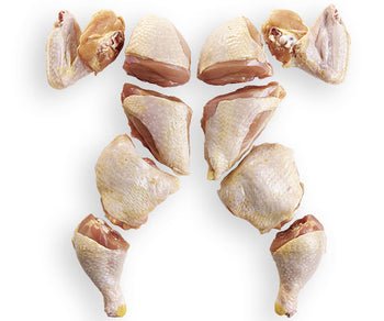 Cut stewing hen pieces arranged on a white background for cooking and stewing.