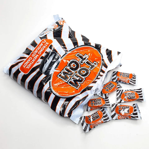 Tom Tom strong menthol flavored black and white striped hard candy in orange and white packaging by Cadbury