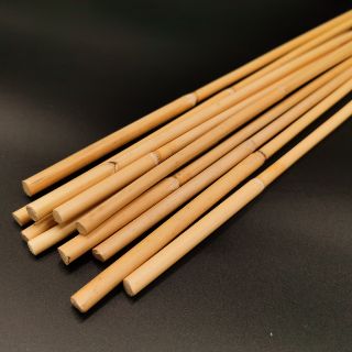 Cane sticks arranged on a dark surface.