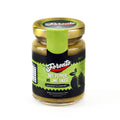 Bottle of Foronto Hot Pepper and Lime Sauce with fresh peppers and lime fruits