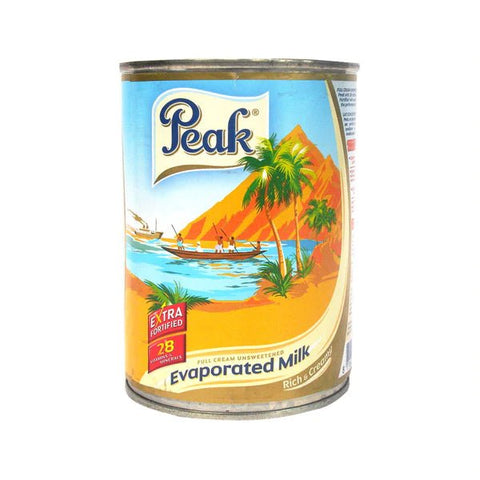 Peak Evaporated Milk can, 900g, ideal for enhancing beverages, cooking, and baking.