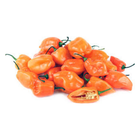Pile of bright orange habanero peppers with one cut open showing seeds inside isolated on white background