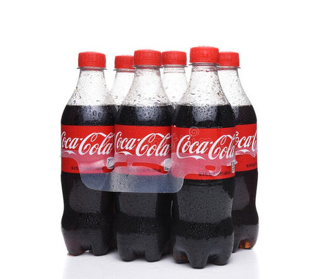 Six-pack of Nigerian Coca Cola PET bottles with red labels and caps.